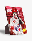 Personalized pet standing canvas featuring a dog in a red Phillies baseball uniform, hat, and holding a bat, against a red cityscape background.