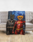 Personalized custom pet blanket featuring two dogs as superhero portraits, Batdog and Flash Doggo, on a gray sofa.