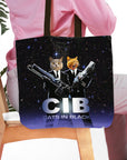 Personalized black tote bag with two custom cat portraits dressed as "Cats in Black" agents.
