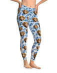 Custom blue leggings with a pattern of brown dog faces and blue palm leaves.