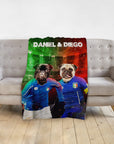 Personalized blanket with two pug dog portraits in blue soccer jerseys against a red and green background.