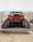 Personalized 2 pet blanket with custom dog portraits driving a red Jeep on a desert road.