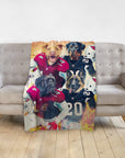 Personalized blanket with four dogs in football uniforms, draped over a grey sofa.