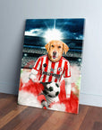 Golden Retriever in a red and white striped Brentford football kit holding a soccer ball on a canvas.