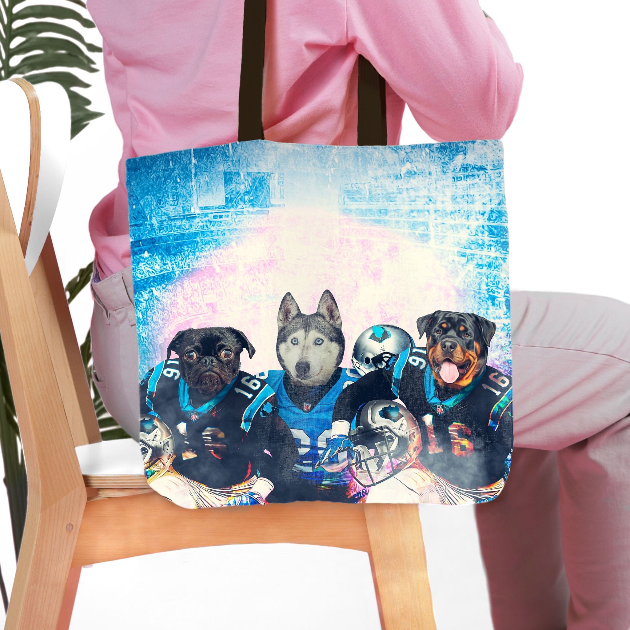Personalized 3-pet tote bag with custom dog portraits in Carolina football jerseys.