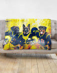 Personalized 3-pet blanket with dogs in football uniforms, yellow and blue, on a gray sofa.