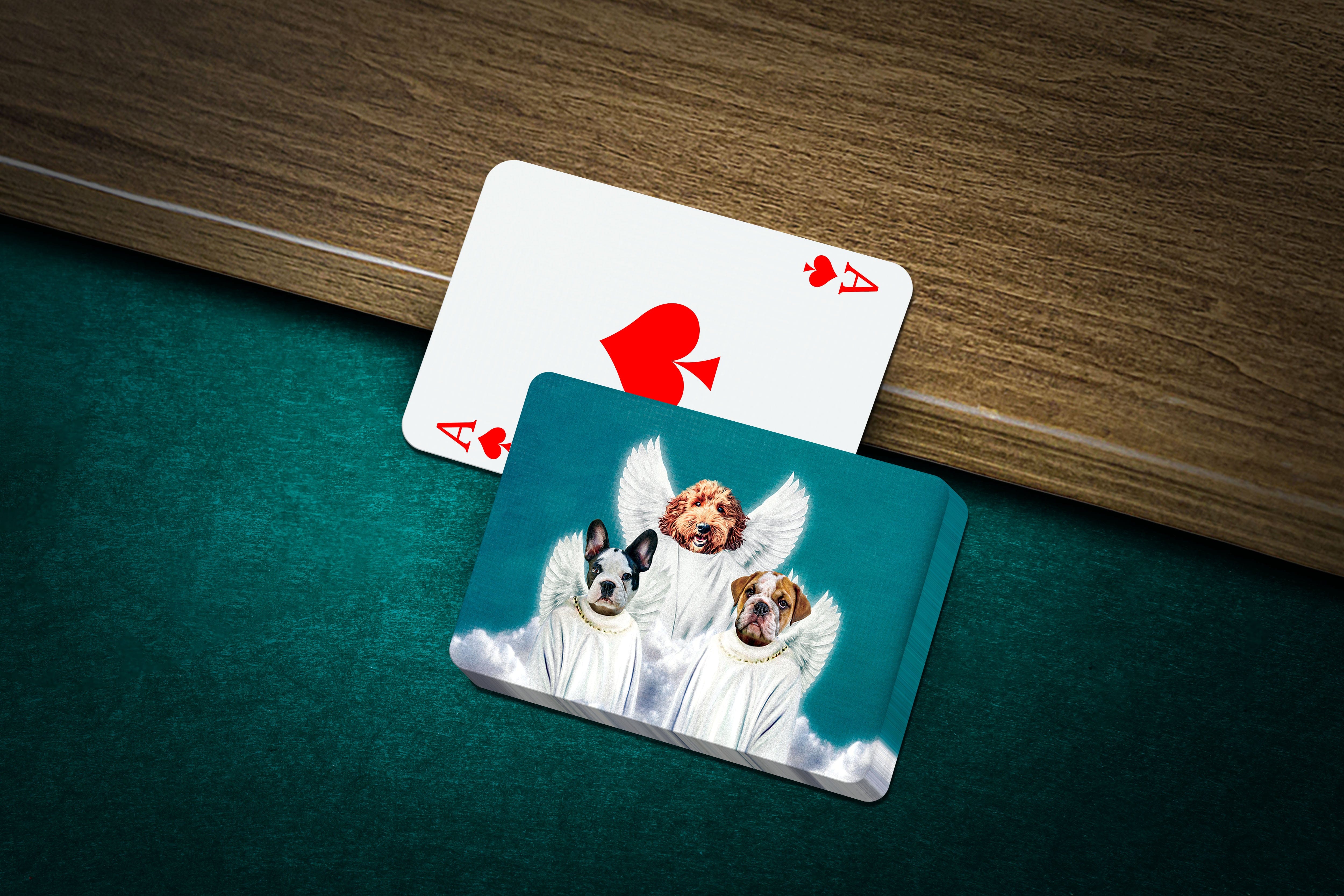 Custom playing cards featuring three pets as angels, with an Ace of Spades card beside the deck.