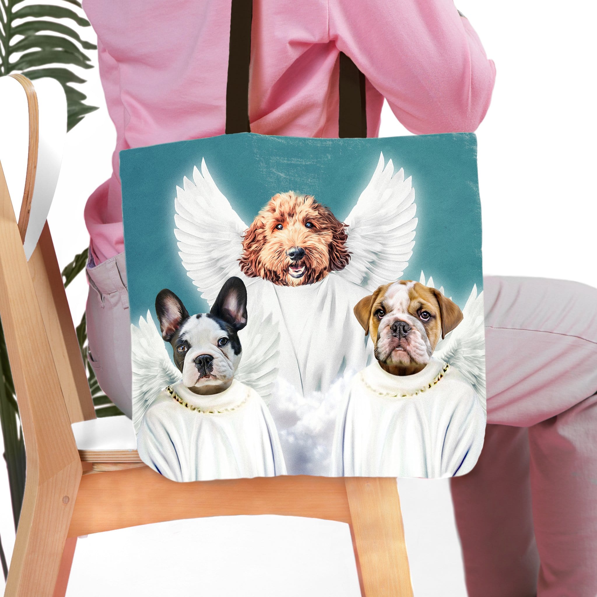 Personalized tote bag with three pet portraits as angels on a blue background.