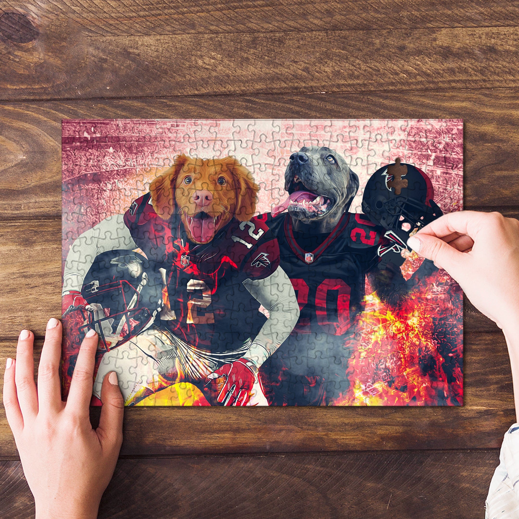 Personalized 2 pet puzzle featuring dogs in Atlanta Falcons football uniforms, with hands assembling pieces.