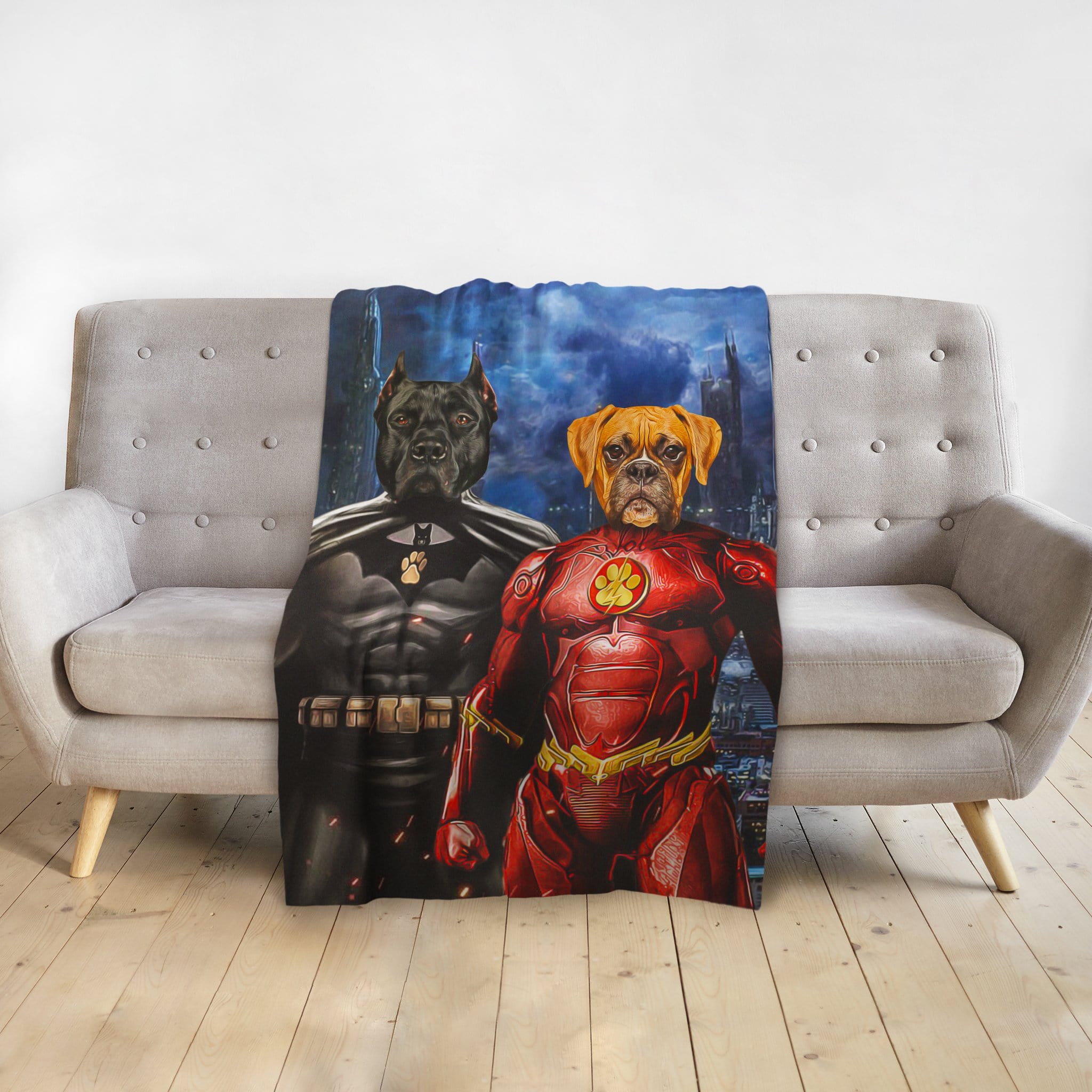 Personalized custom pet blanket featuring two dogs as superhero portraits, Batdog and Flash Doggo, on a gray sofa.