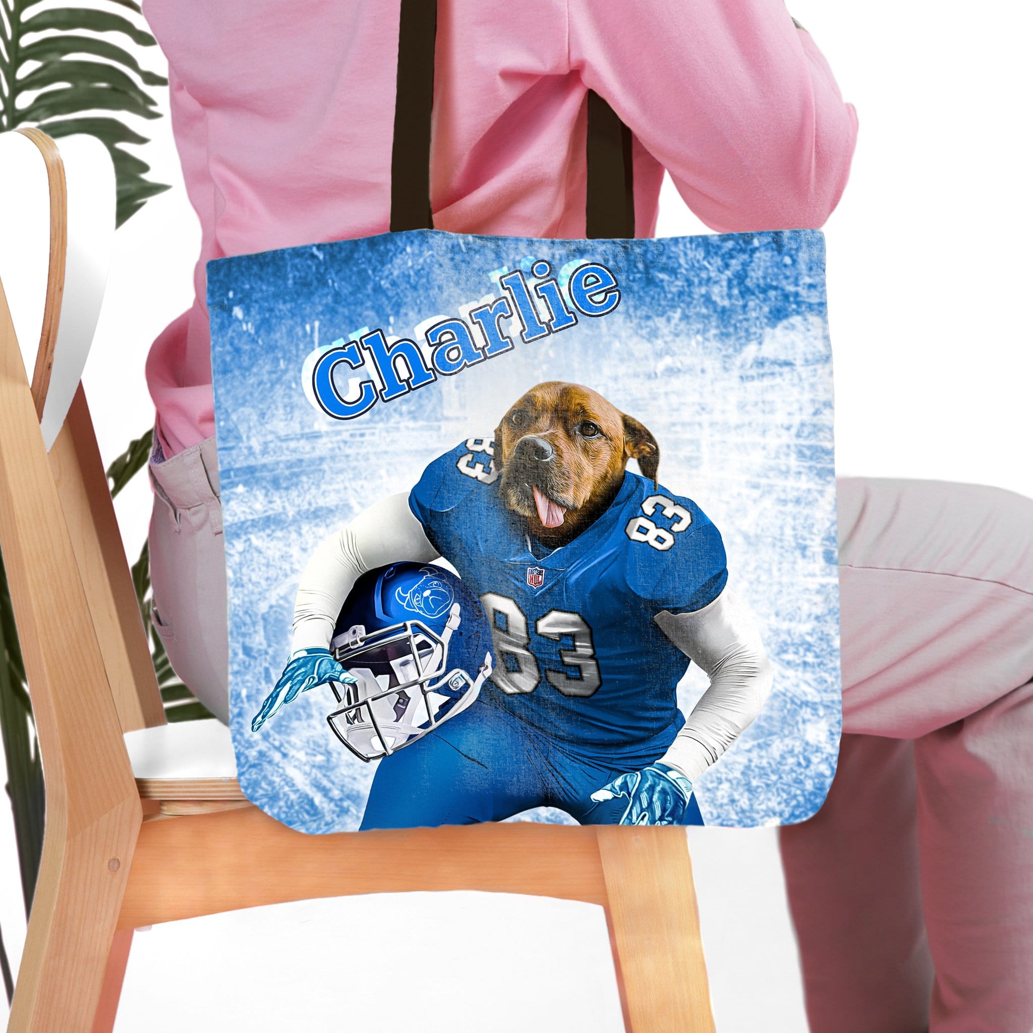 Personalized tote bag with a dog's portrait in a blue football uniform, name "Charlie" above.