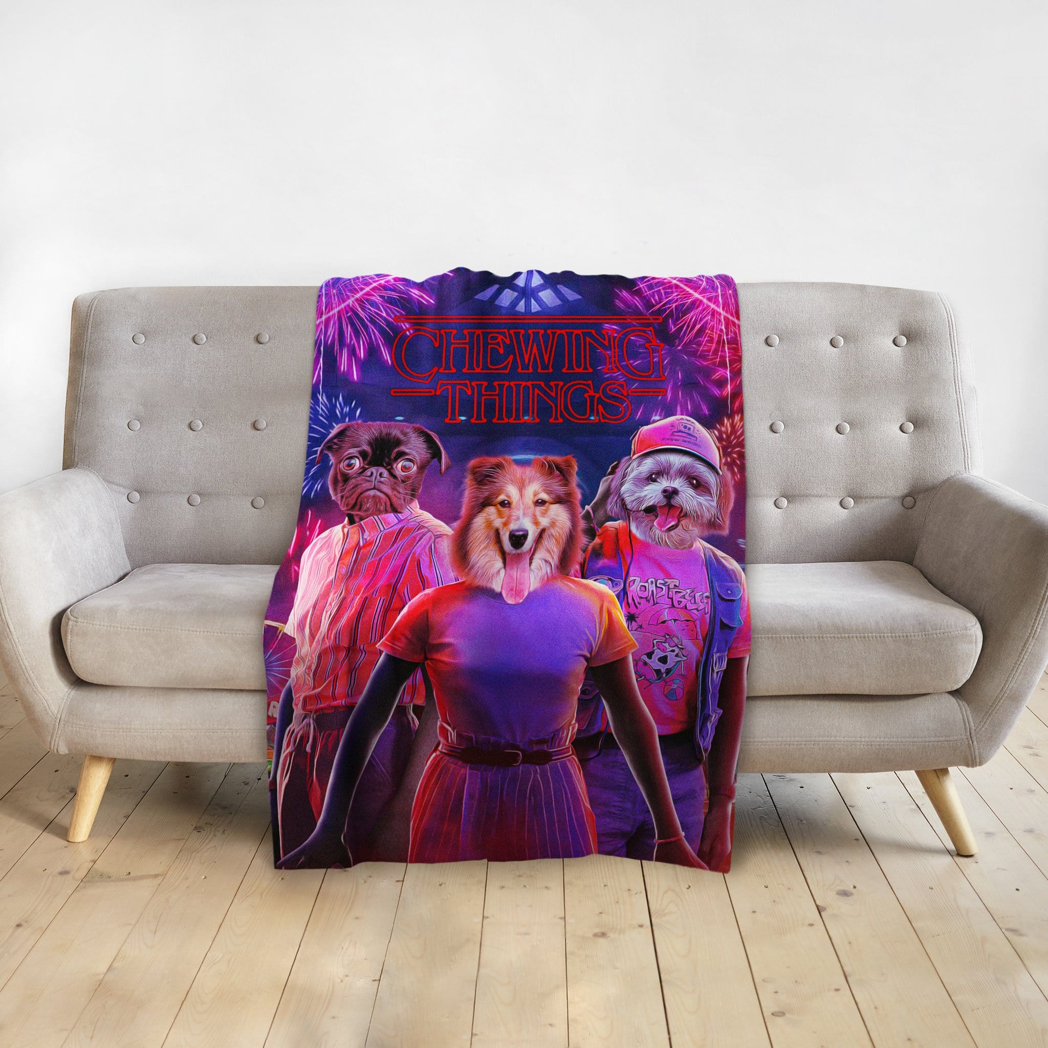 Custom personalized blanket with three pet portraits in a "Chewing Things" design, draped over a sofa.