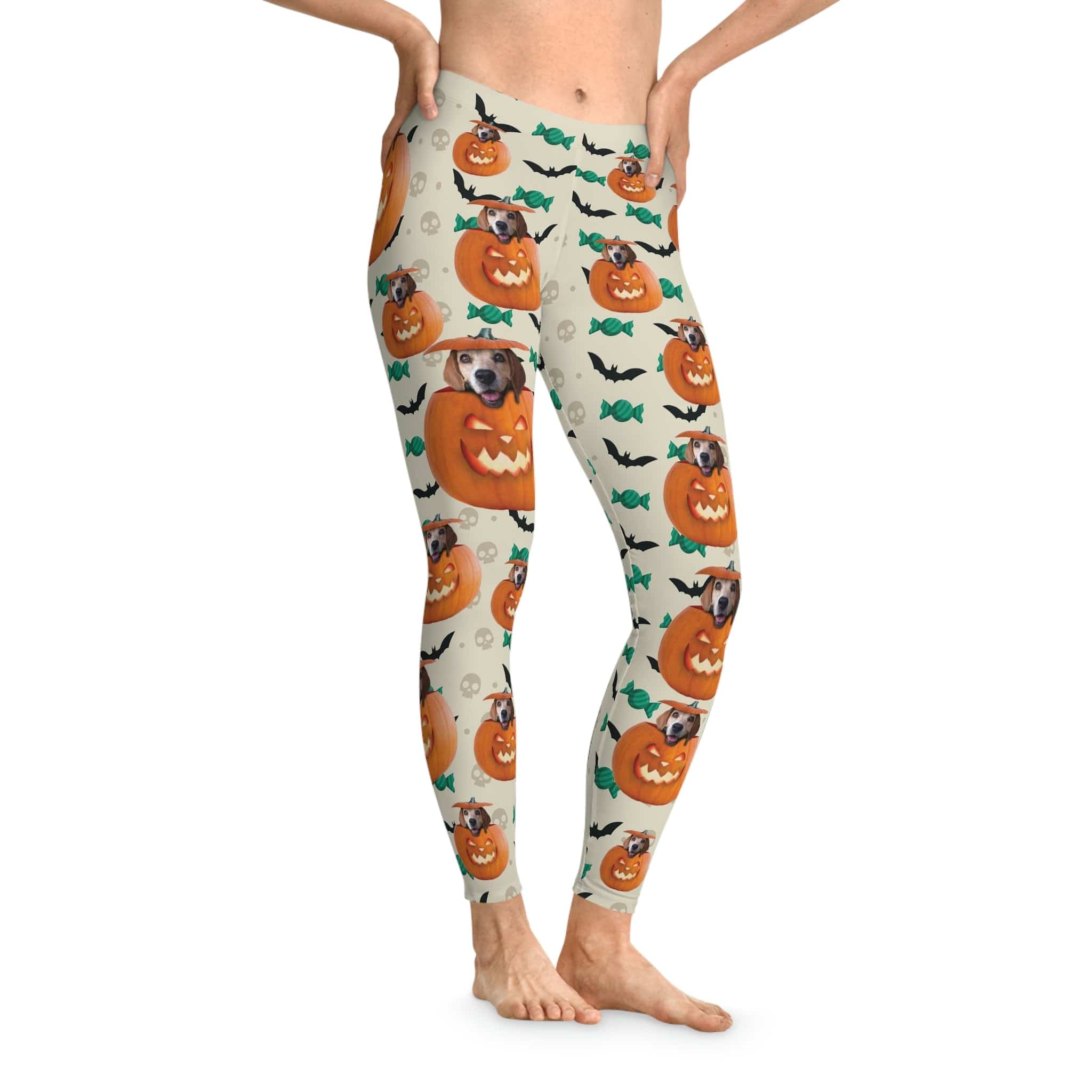 Custom Halloween pumpkin leggings with dogs, bats, and candy on a light background.