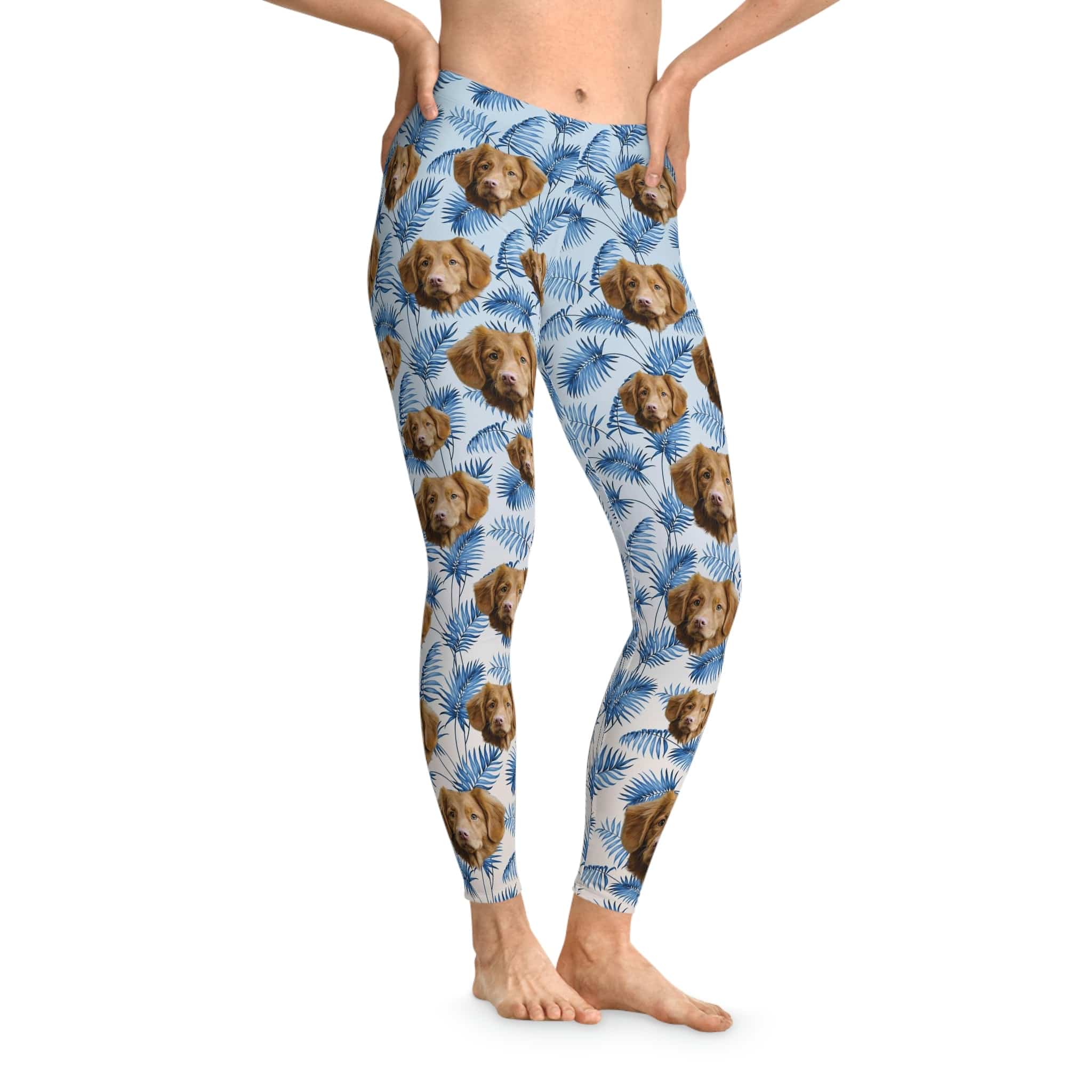 Custom blue leggings with a pattern of brown dog faces and blue palm leaves.