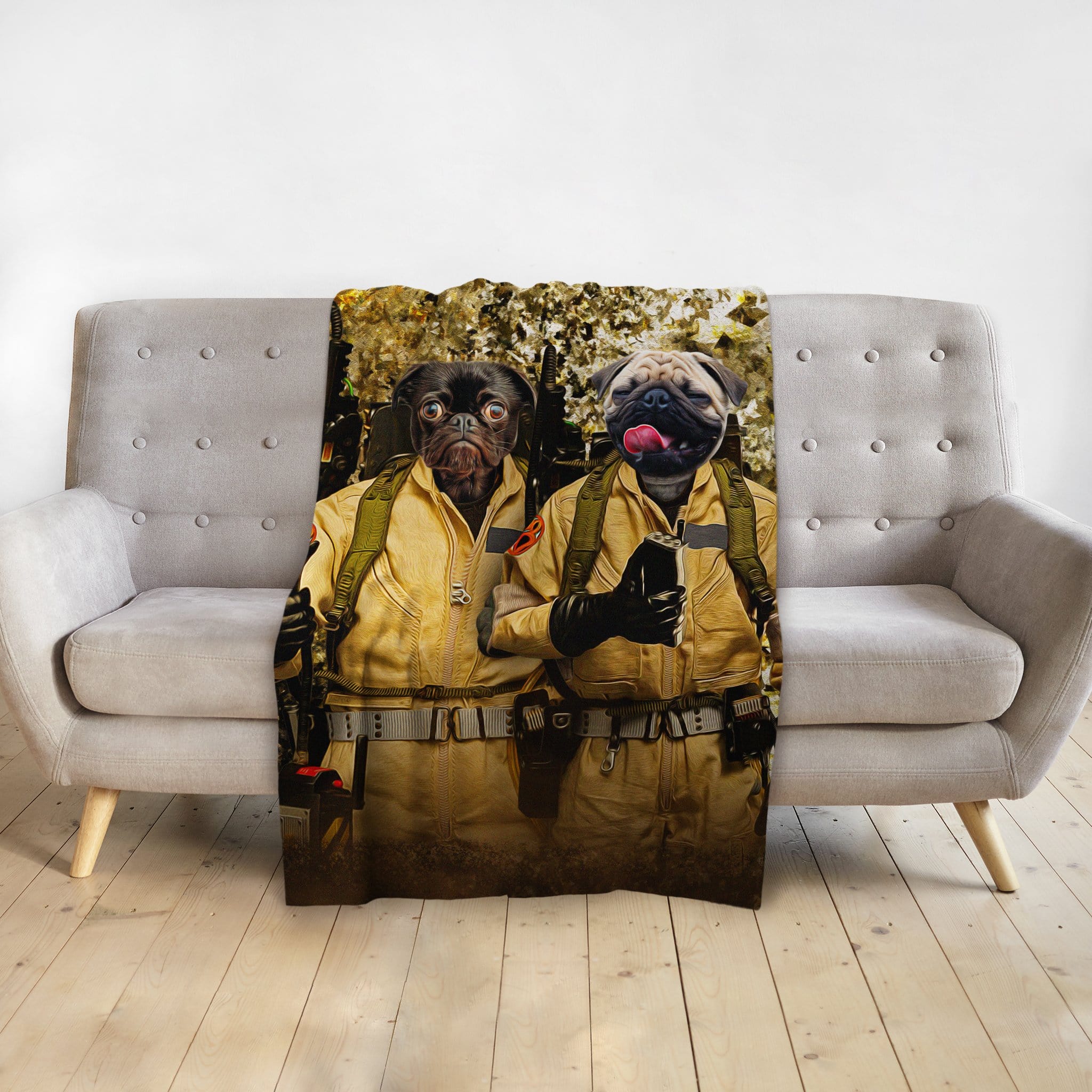 Personalized custom pet portrait blanket featuring two pugs in Ghostbusters costumes on a gray sofa.