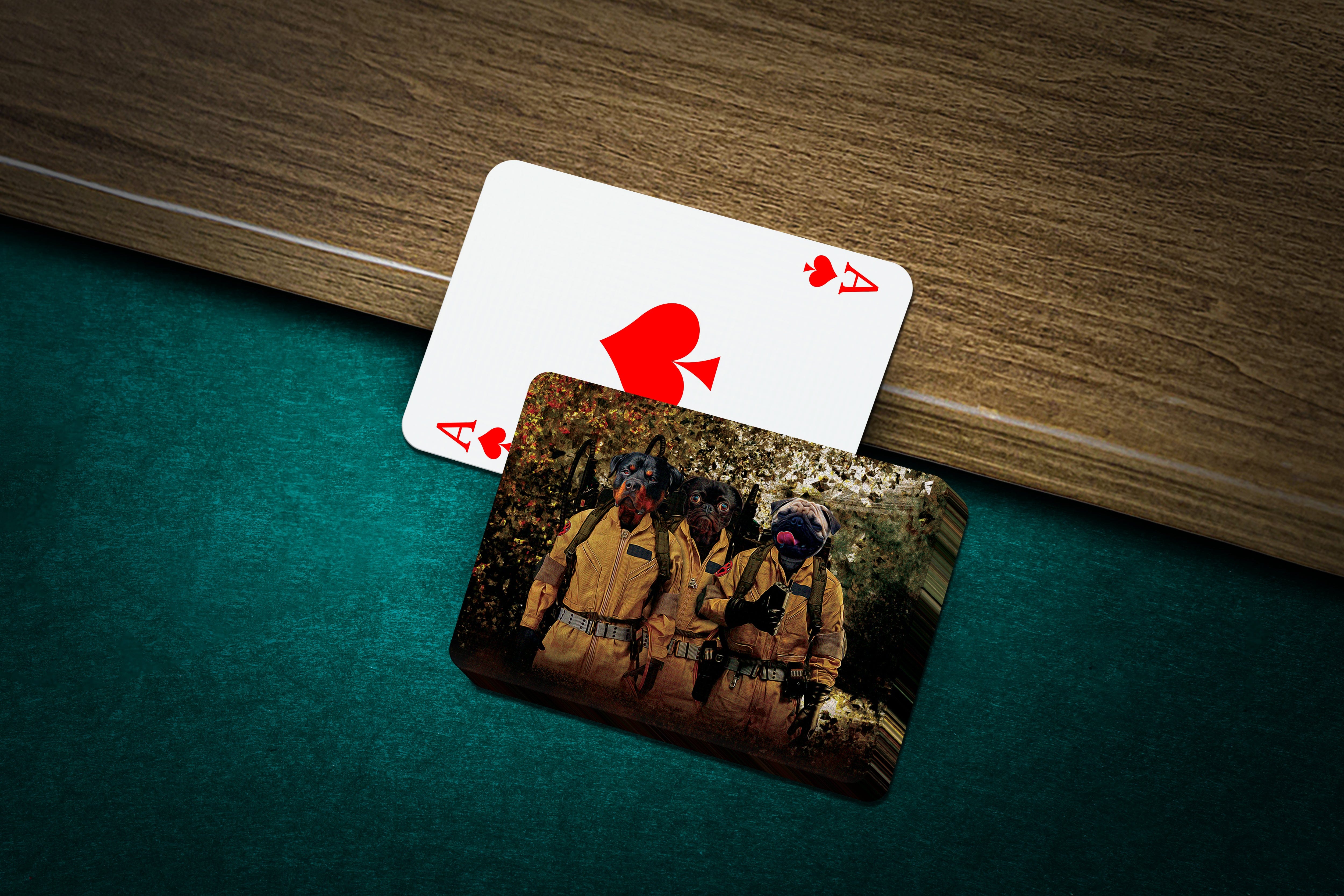 Custom 'Dogbusters' personalized playing cards featuring three pets in cartoon style on a green felt table.