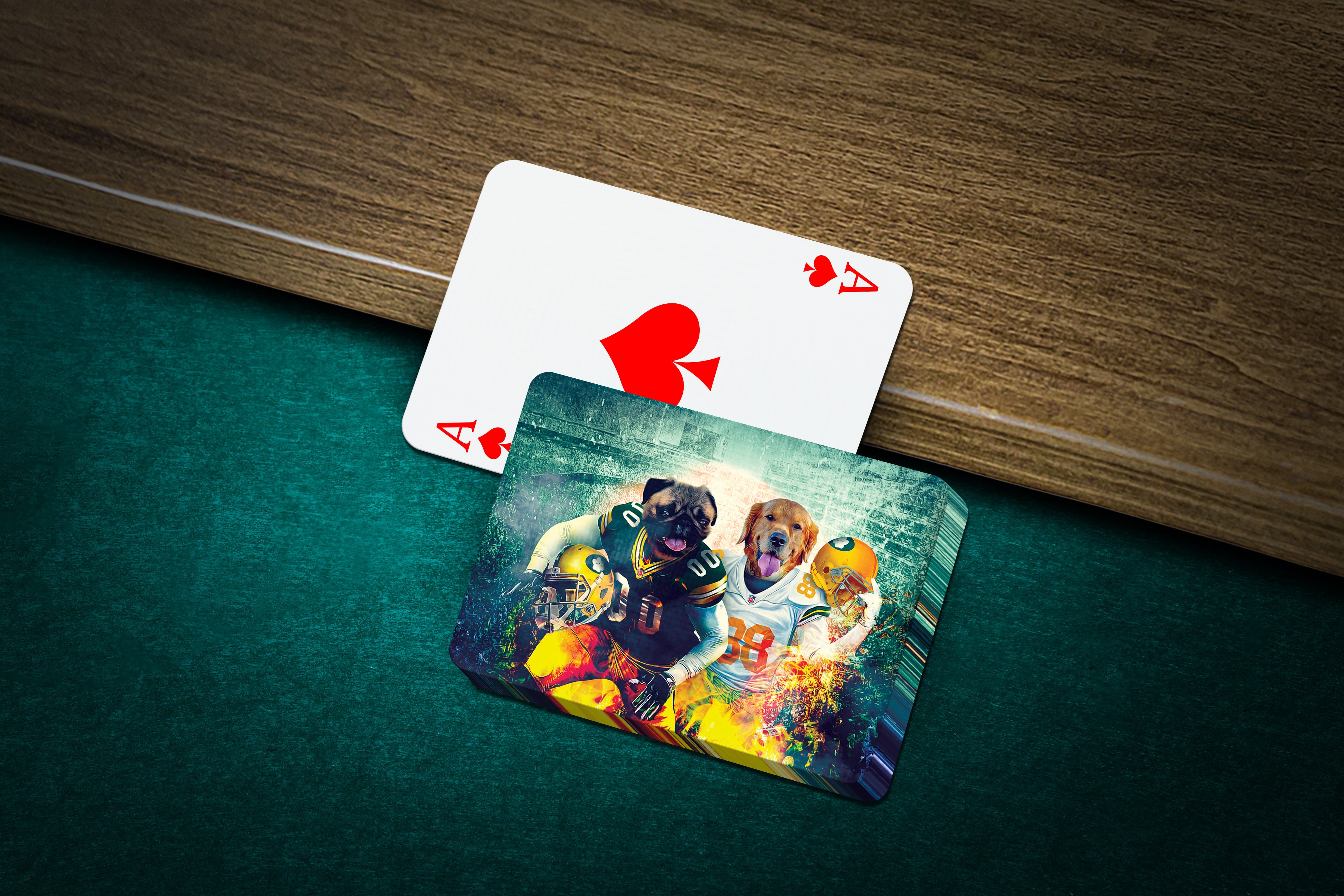 Personalized playing cards featuring two dogs in Green Bay football uniforms on a green felt table.