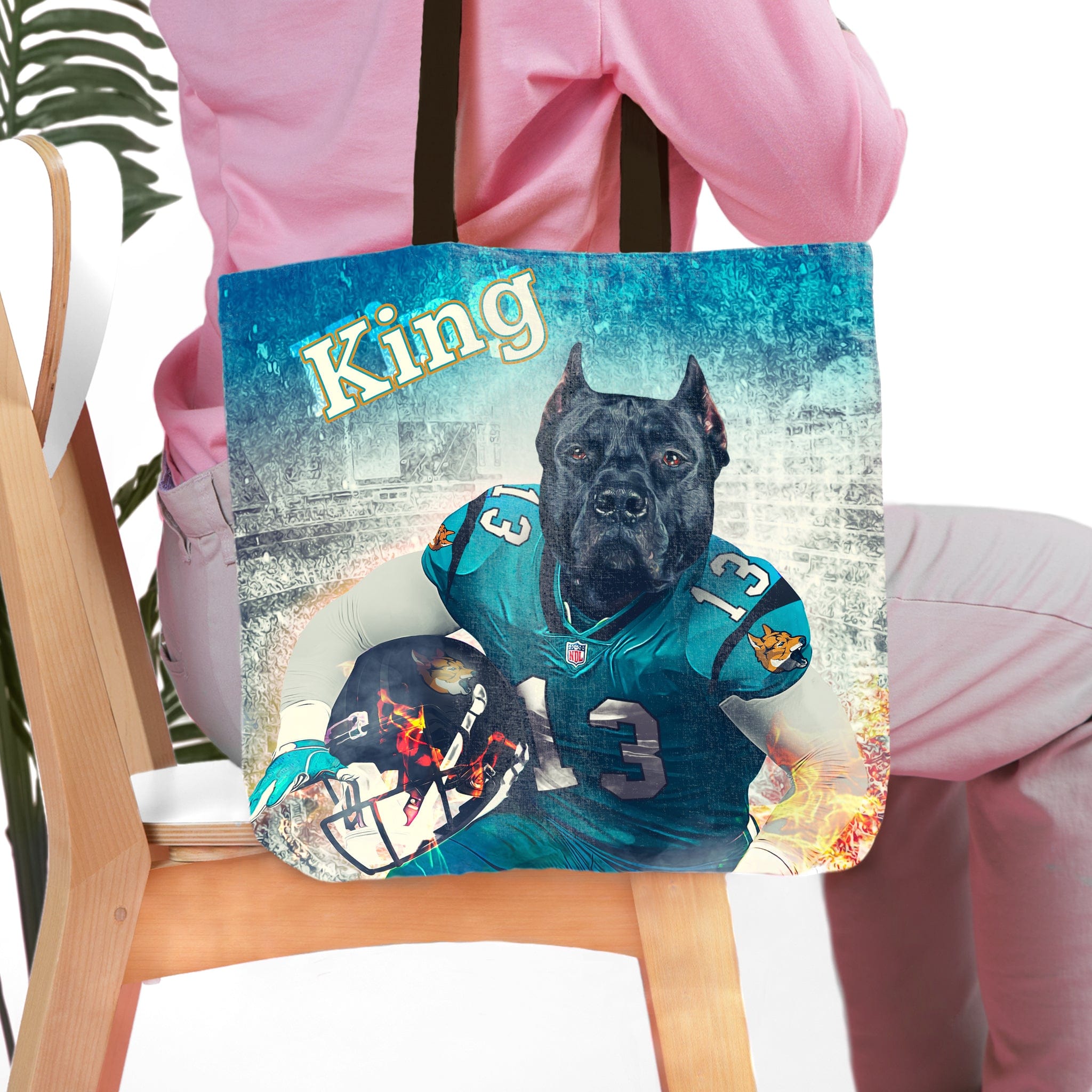 Personalized tote bag with a custom pet portrait of a black dog in a teal football uniform.