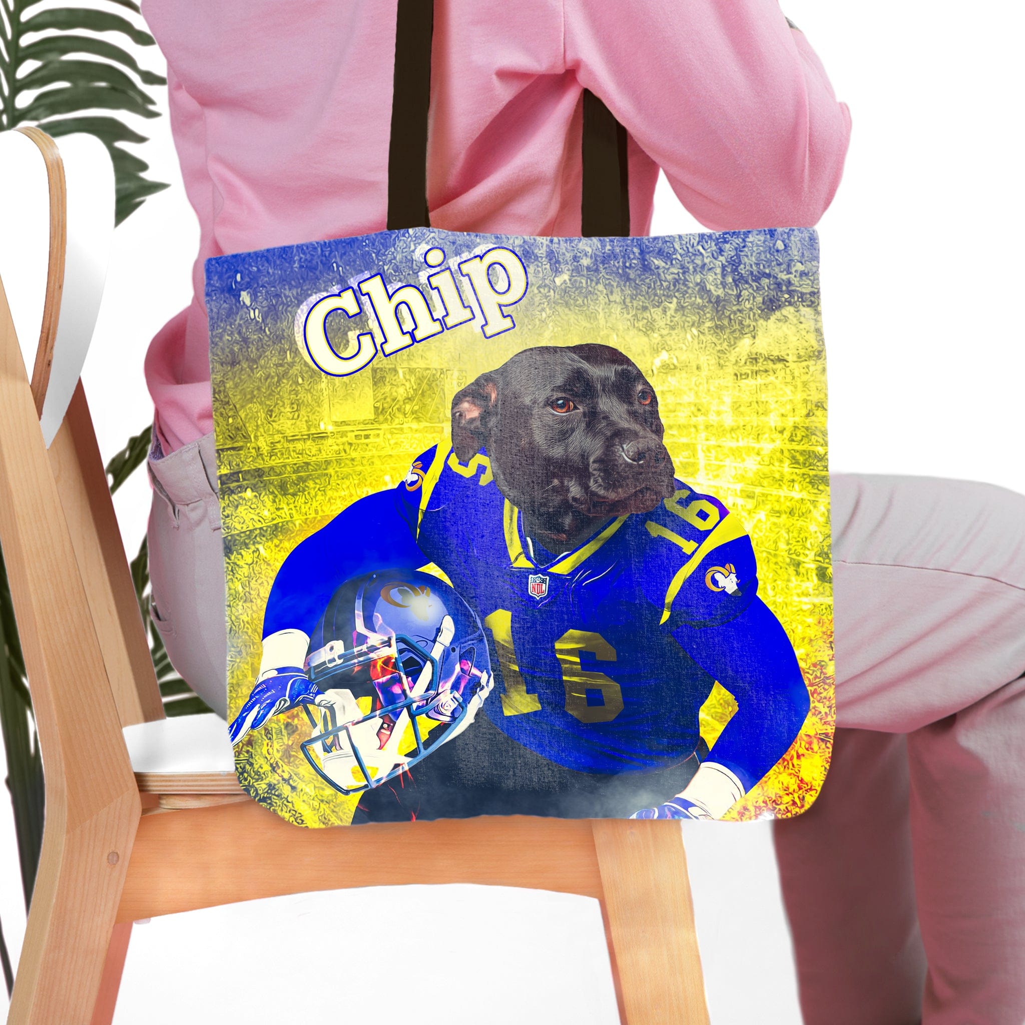 Personalized tote bag with a custom pet portrait of a black dog in a blue football uniform.