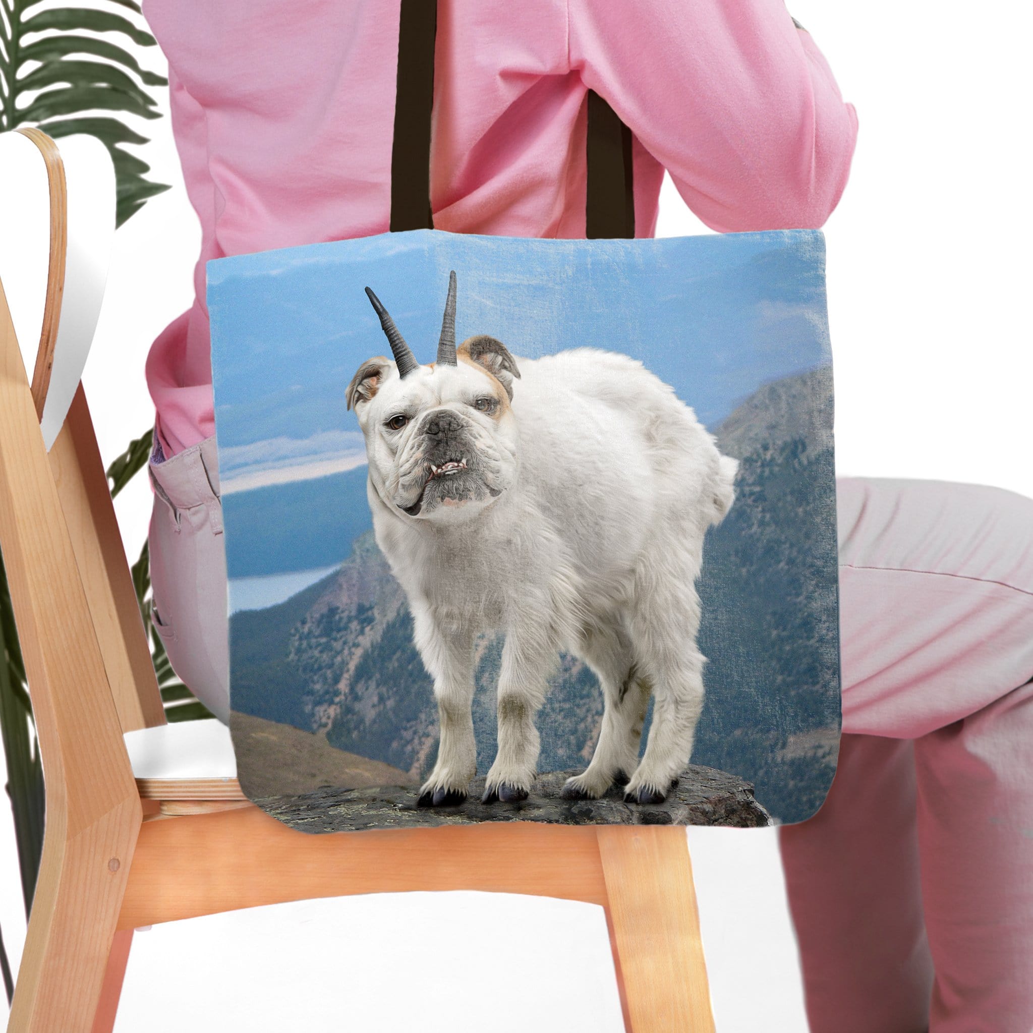 Personalized tote bag with a bulldog pet portrait as a mountain goat on a blue mountain landscape.
