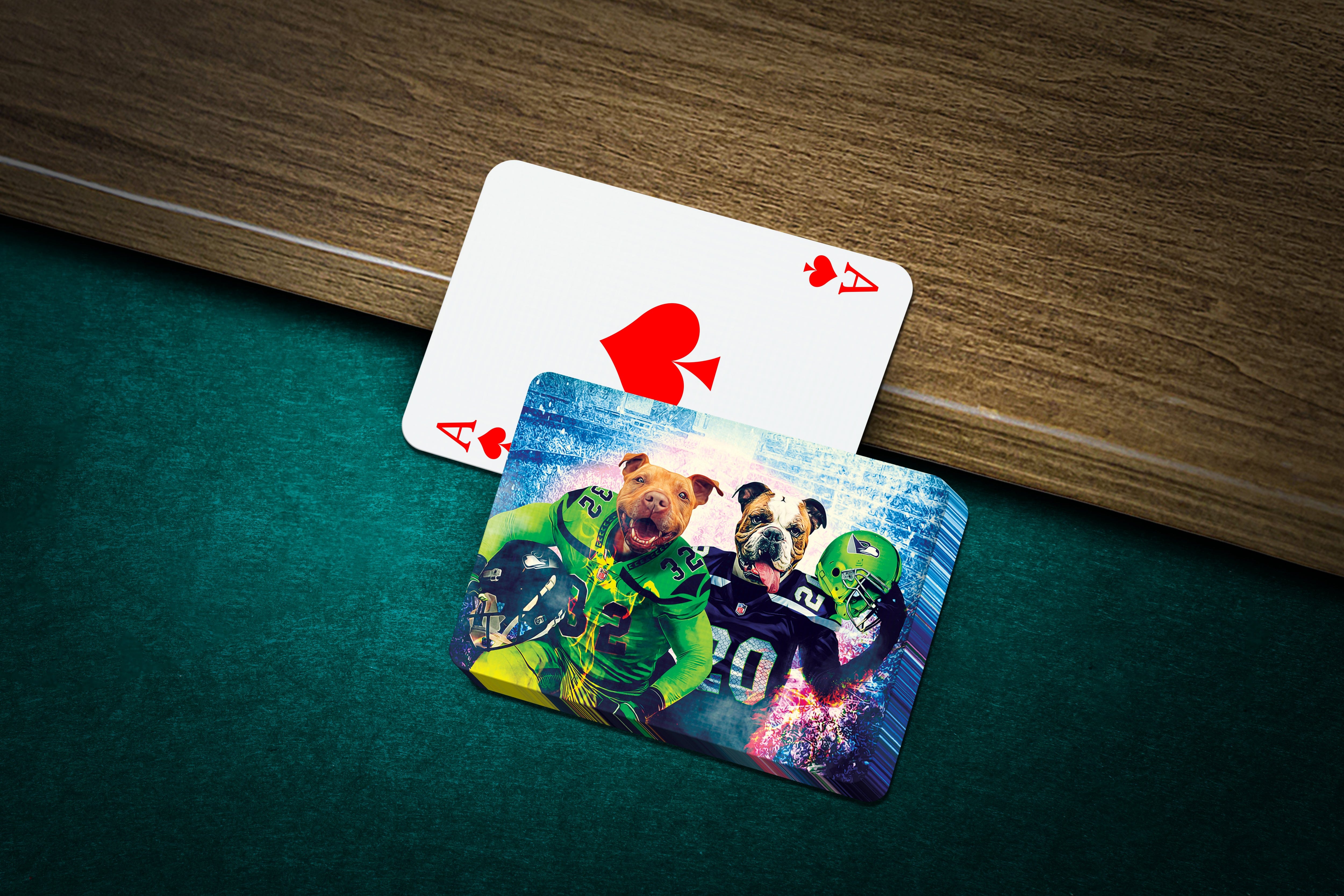 Personalized playing cards featuring two dogs in Seattle football uniforms on a green felt table.