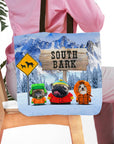 Personalized 'South Bark' tote bag with three custom pet portraits in winter clothes against a snowy mountain backdrop.