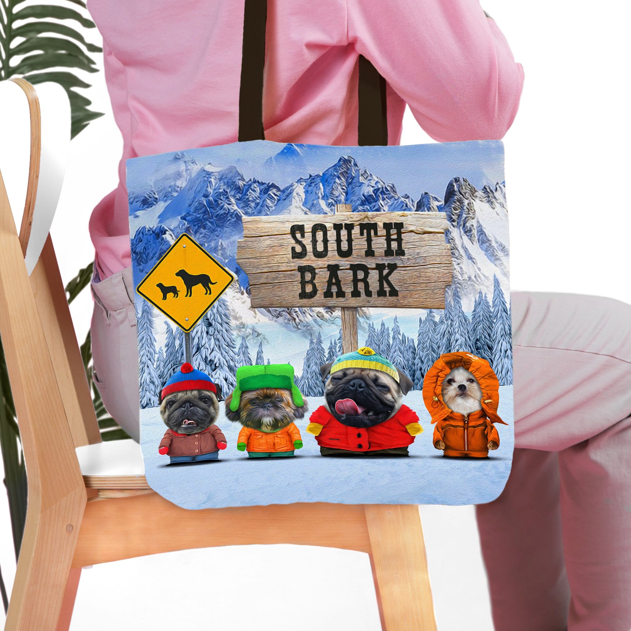 Personalized 'South Bark' tote bag with four custom pet portraits in winter outfits against a snowy mountain backdrop.