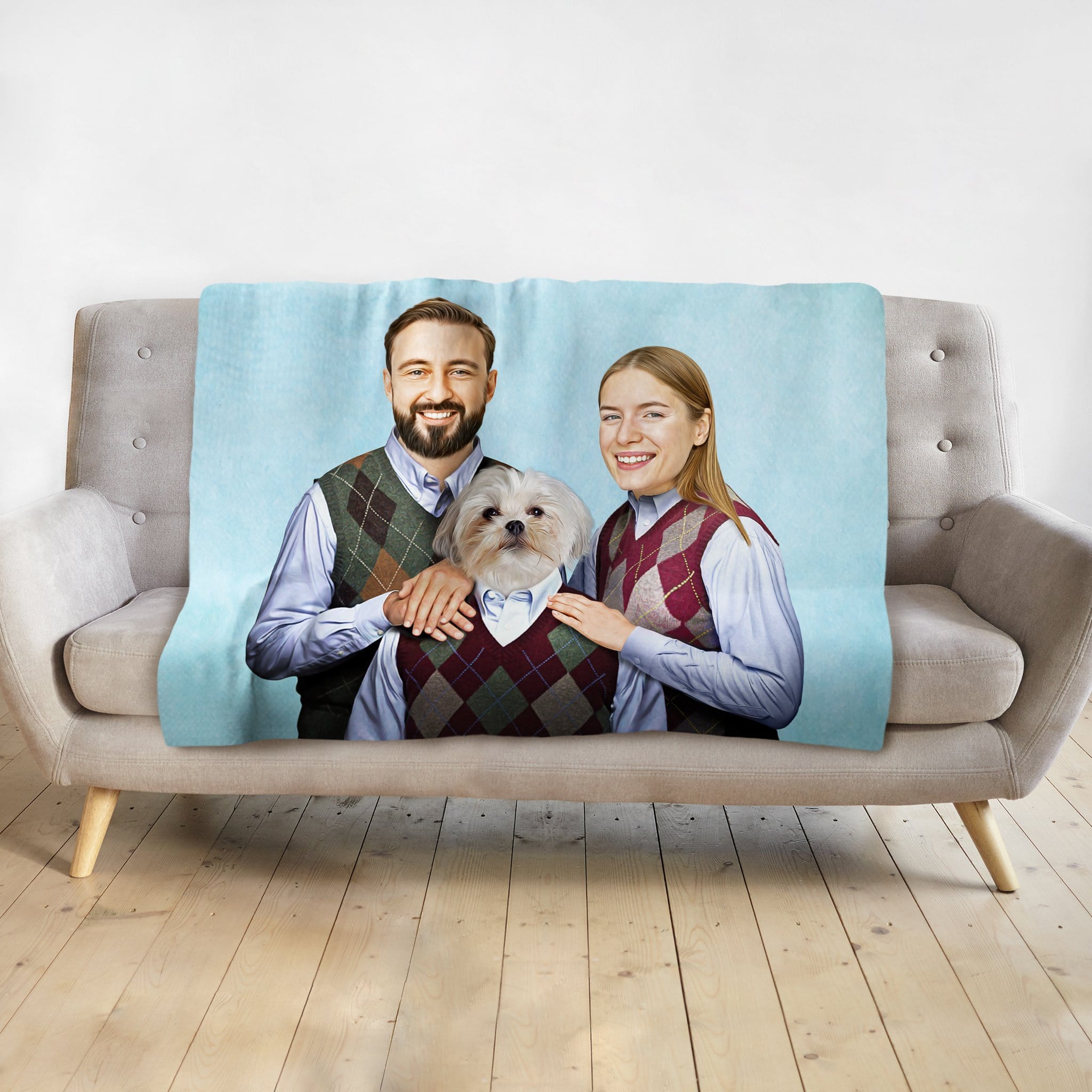 Personalized light blue blanket with a custom portrait of a couple and their dog in matching argyle sweaters.