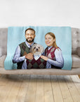 Personalized light blue blanket with a custom portrait of a couple and their dog in matching argyle sweaters.