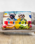 Personalized pet blanket with two dogs in Hawaiian shirts on a beach, surrounded by fruit and drinks.
