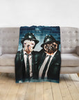 Personalized two-pet blanket featuring dogs in "Blues Doggos" suits against a brick wall.