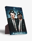 Personalized standing canvas featuring two dogs in black suits and hats against a blue brick wall.