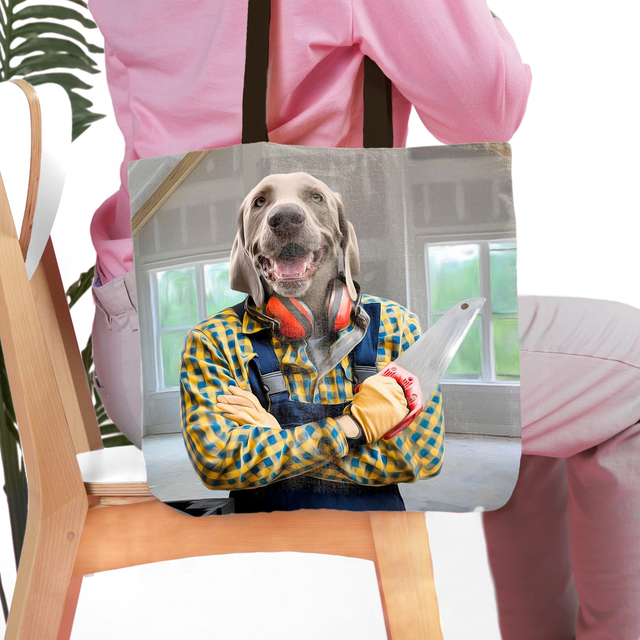 Personalized 'The Carpenter' tote bag with a custom dog portrait in a blue and yellow plaid shirt holding a saw.