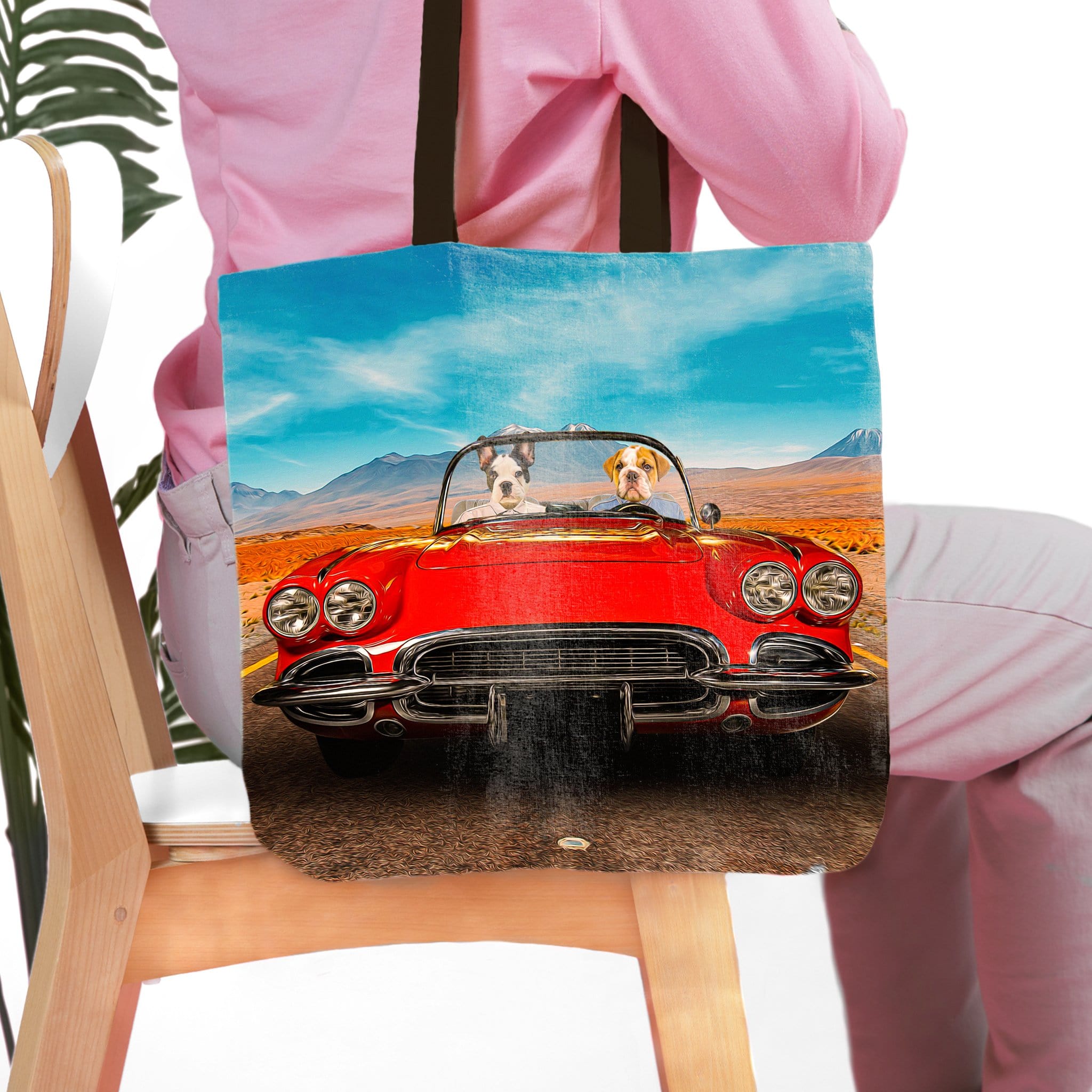 Personalized tote bag with two dog portraits in a red classic car, desert landscape background.
