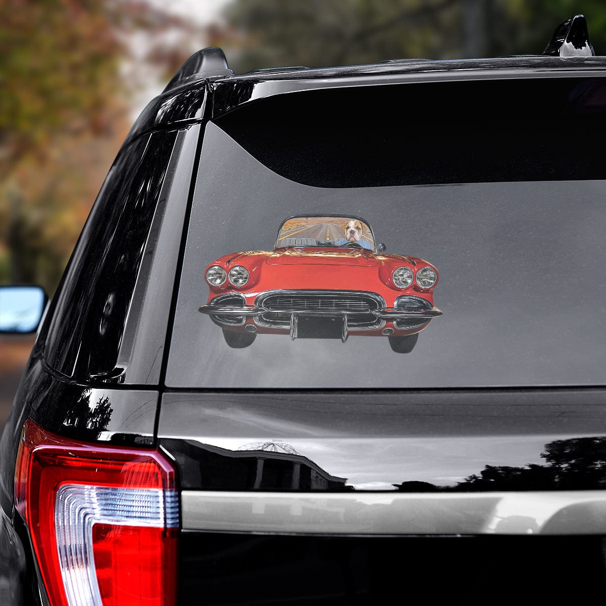 Custom pet decal featuring a dog driving a red classic car, applied to a black SUV rear window.