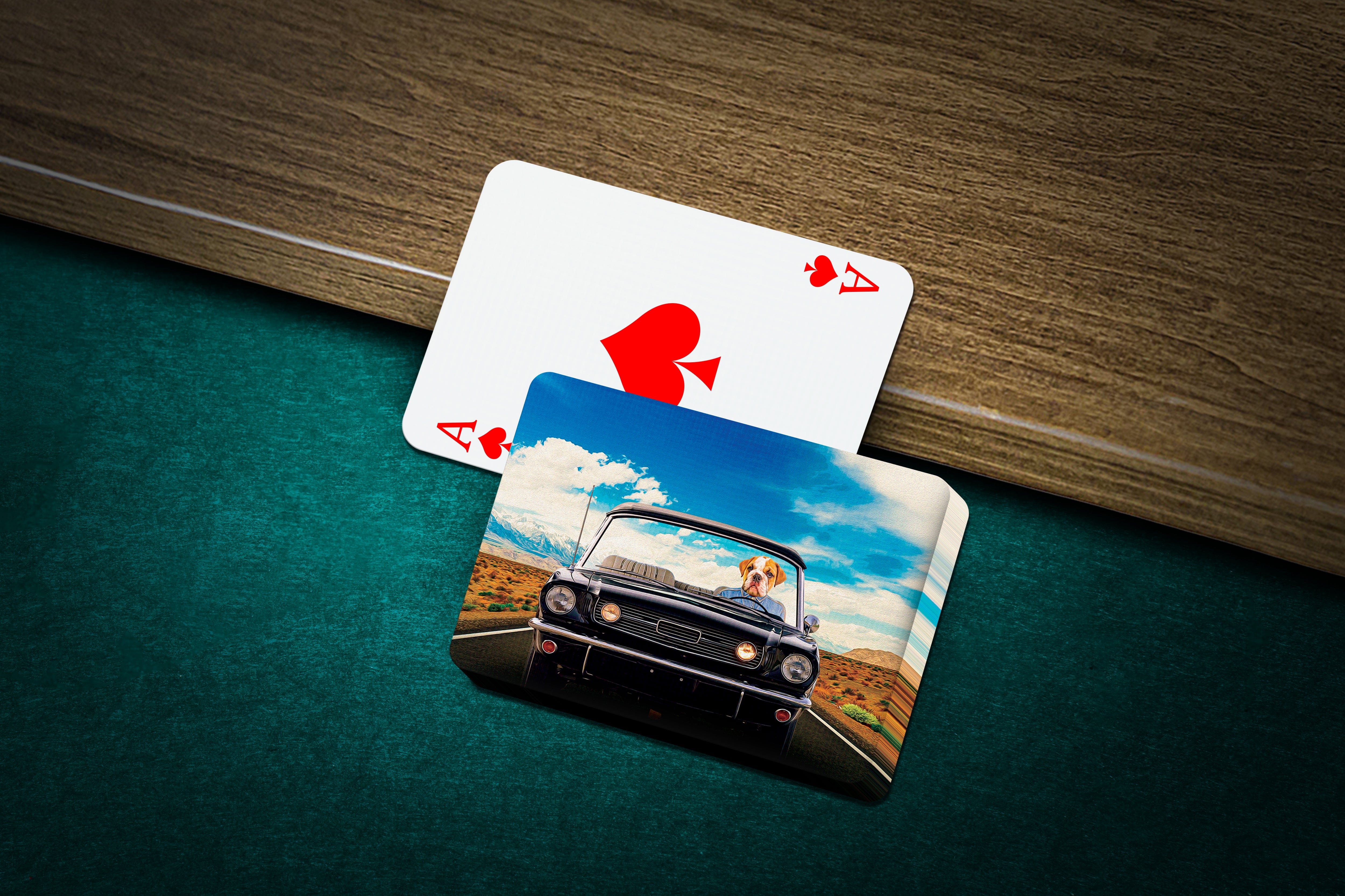 Personalized pet playing cards featuring a dog driving a classic car, on a green felt table.