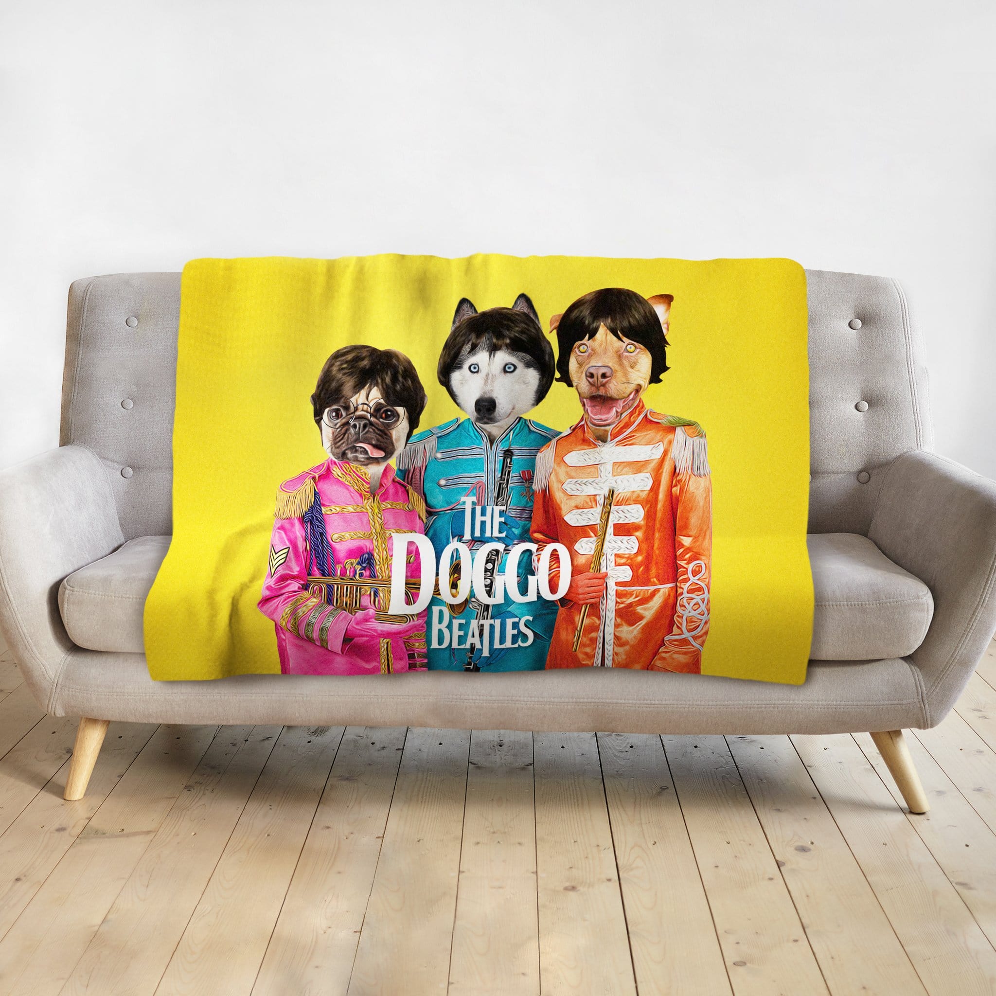 Yellow personalized pet blanket with three dogs in "The Doggo Beatles" renaissance-style costumes on a gray couch.