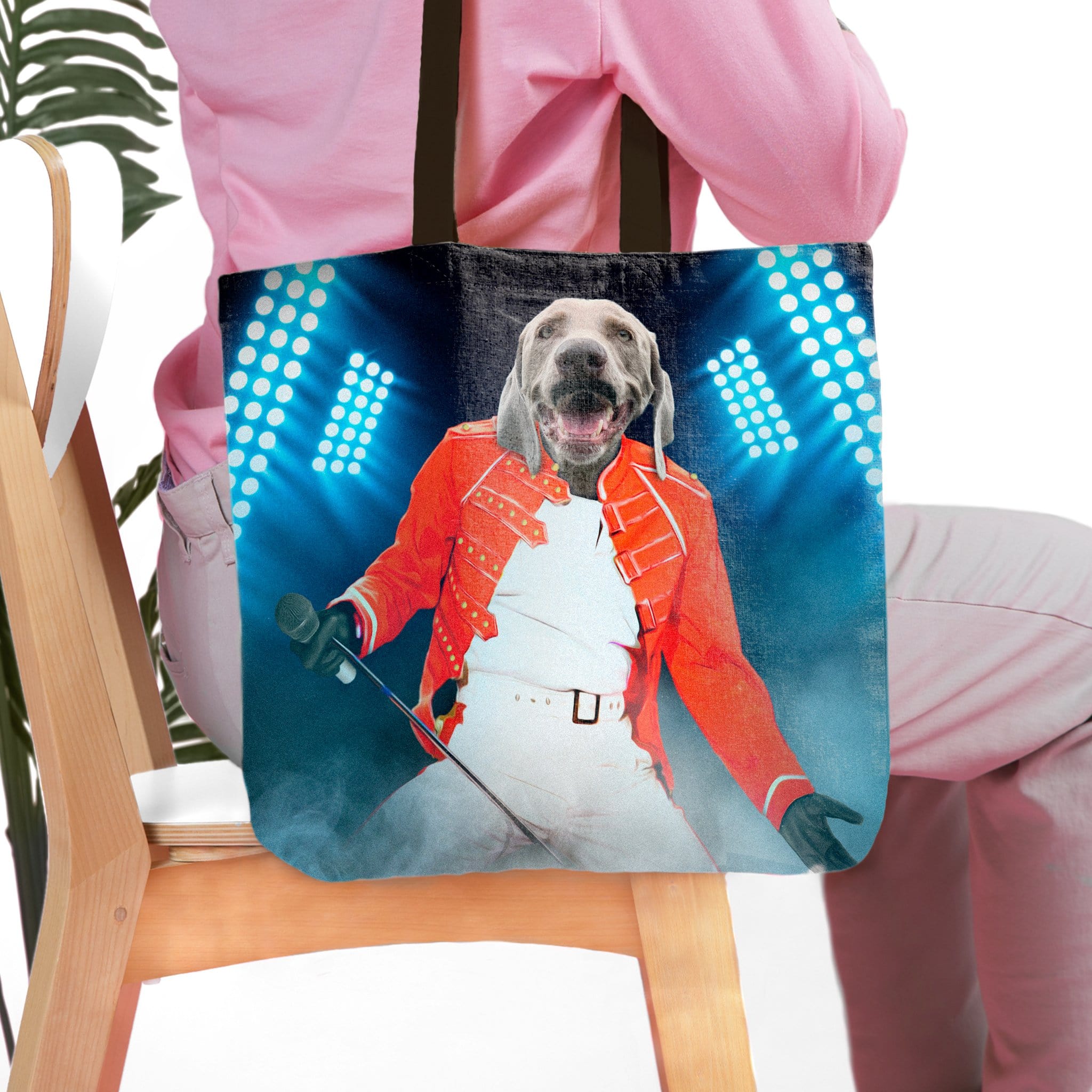 Personalized tote bag with a custom pet portrait of a dog as Freddie Mercury on stage.