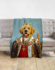 Personalized pet blanket with a golden retriever in a royal king portrait, draped over a gray sofa.