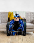 Personalized pet blanket with a bulldog's head on a male cyclist's body, draped over a gray couch.