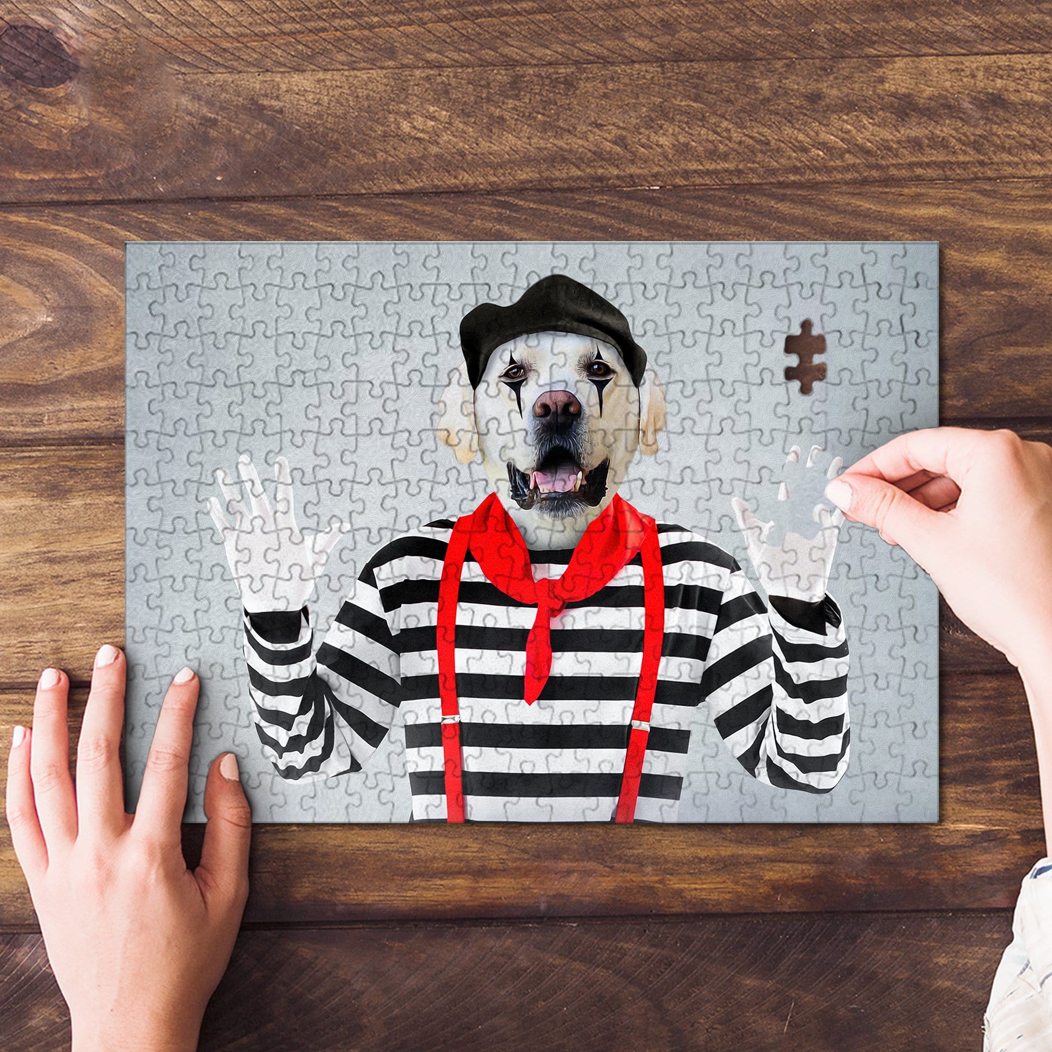 Personalized pet puzzle featuring a white dog dressed as a mime, with a hand placing the final piece.