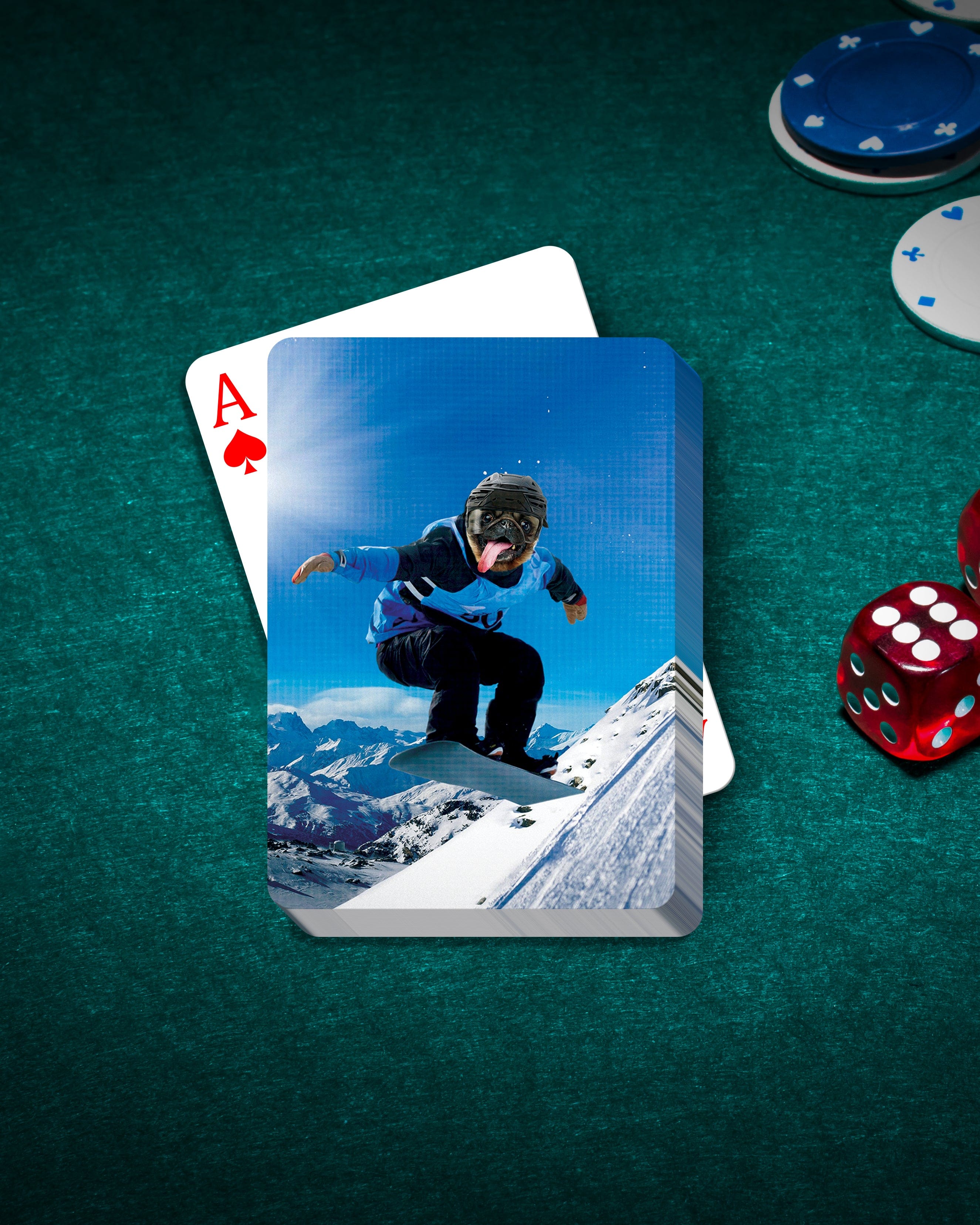 Personalized pet playing cards featuring a dog in a snowboarder portrait on a green felt table with dice and chips.