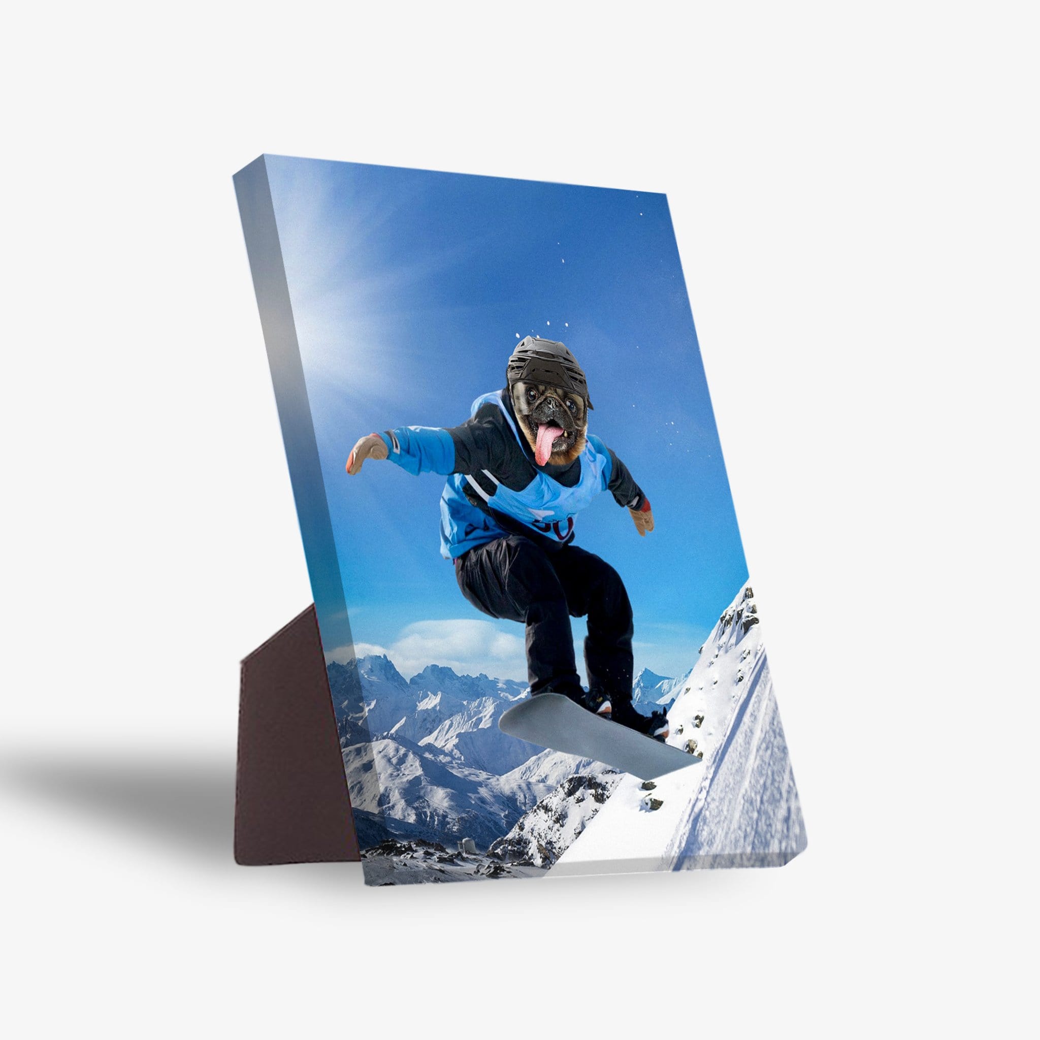 Personalized pet standing canvas featuring a pug's head on a snowboarder in a blue jacket, mid-air over snowy mountains.