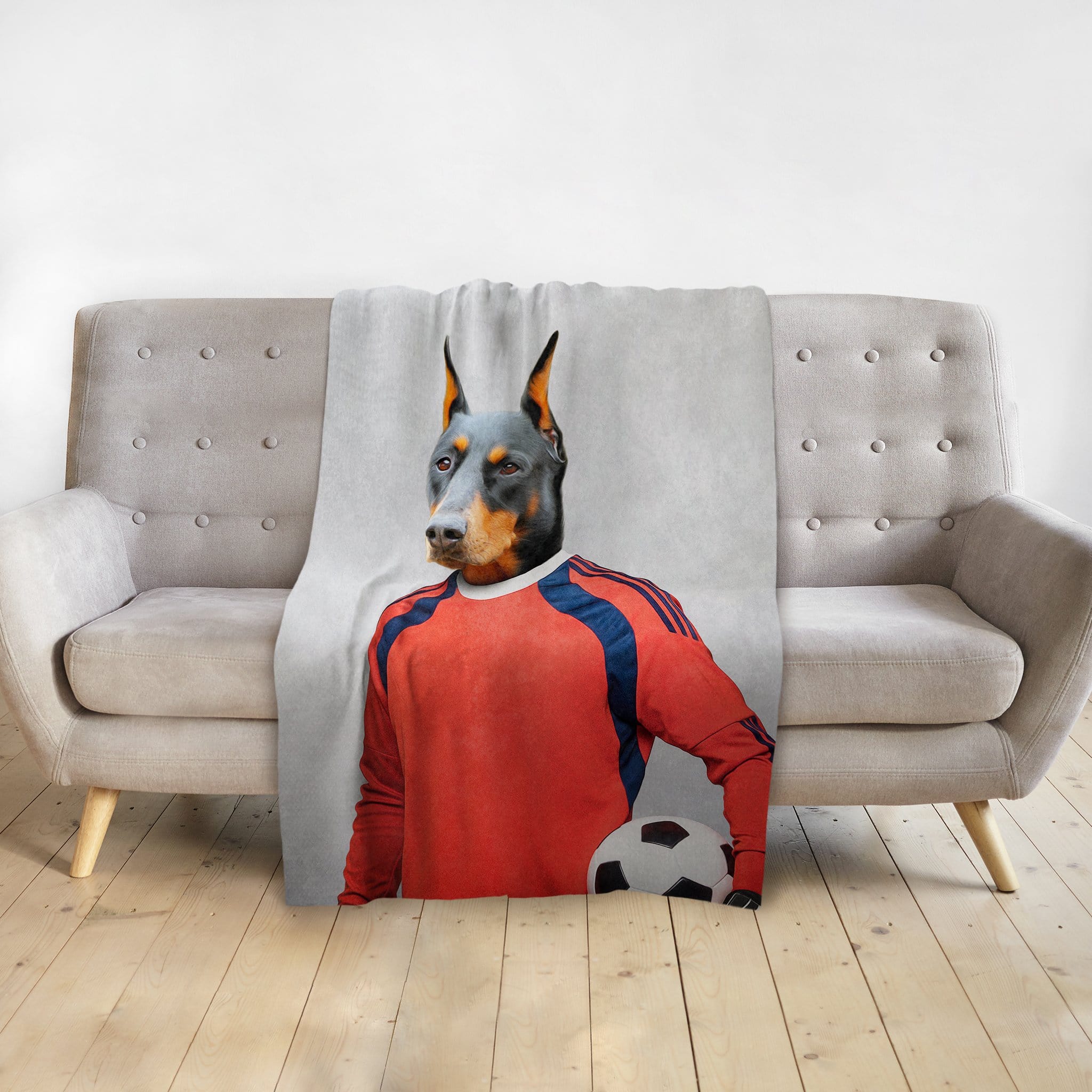 Personalized pet blanket with a Doberman dog portrait as a soccer goalie in a red jersey.