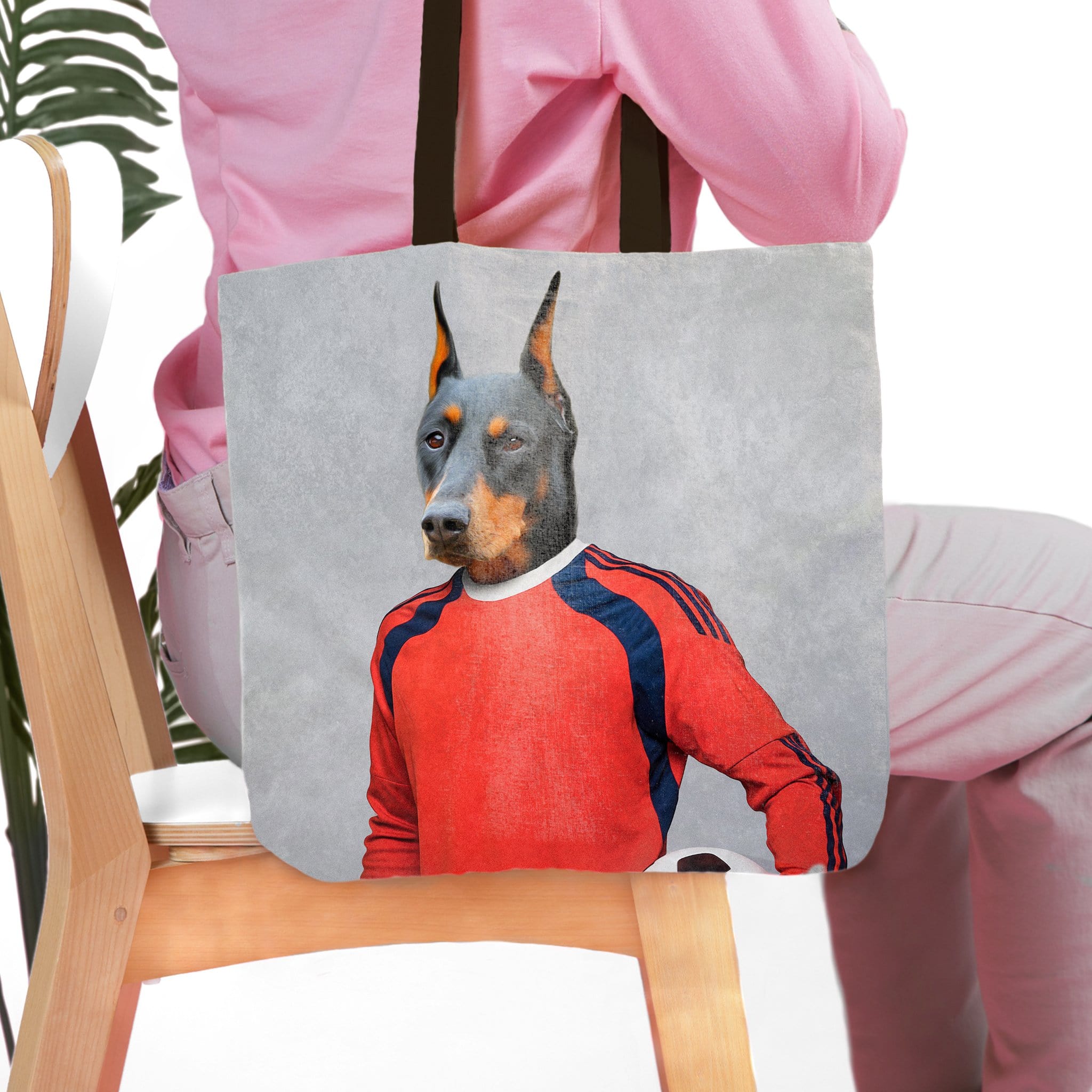 Personalized tote bag with a Doberman pet portrait in a red soccer goalie uniform.