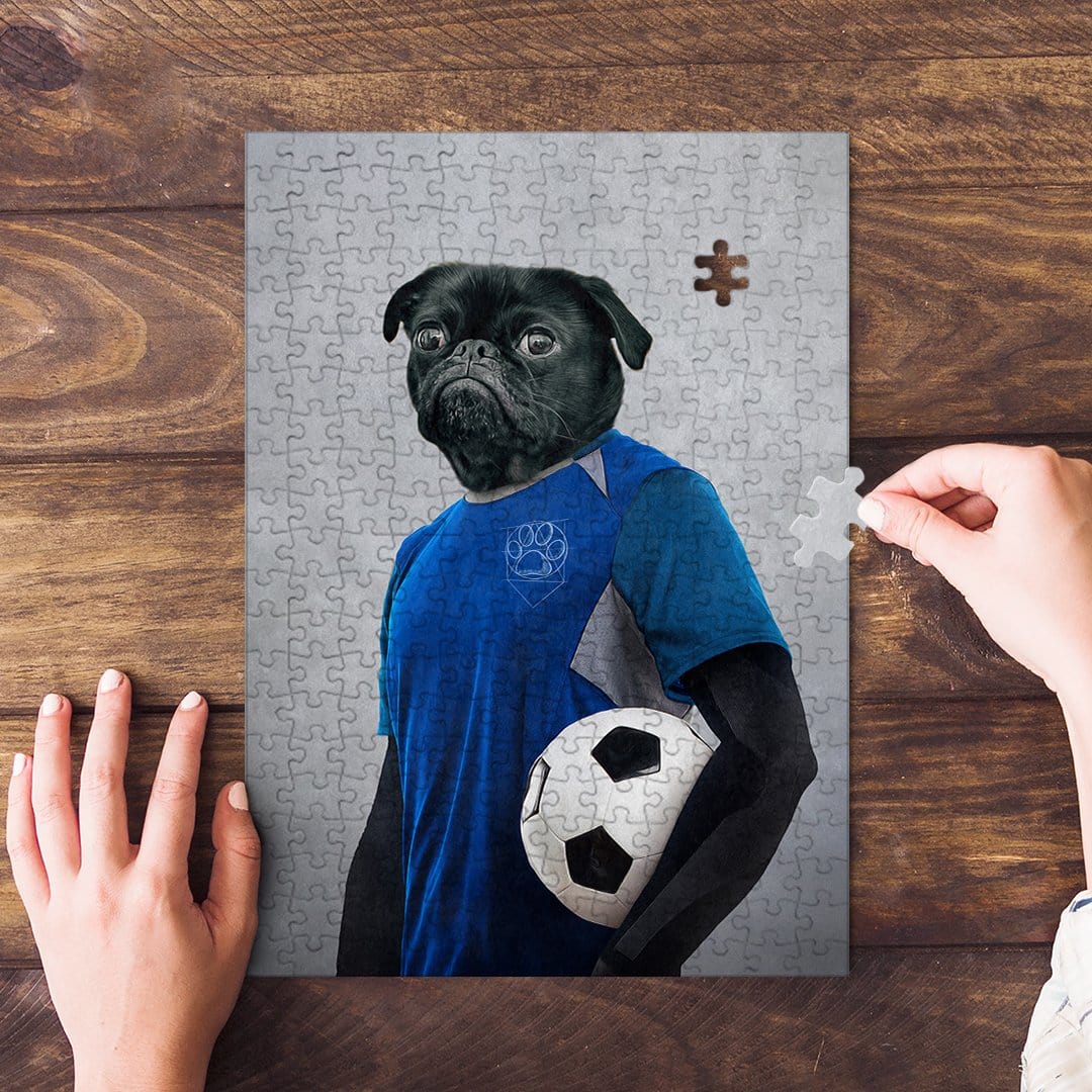 Personalized pet puzzle featuring a black pug in a blue soccer uniform holding a ball, with hands assembling it.
