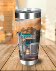 Personalized stainless steel tumbler with a custom dog portrait driving a semi-truck against a mountain sunset.