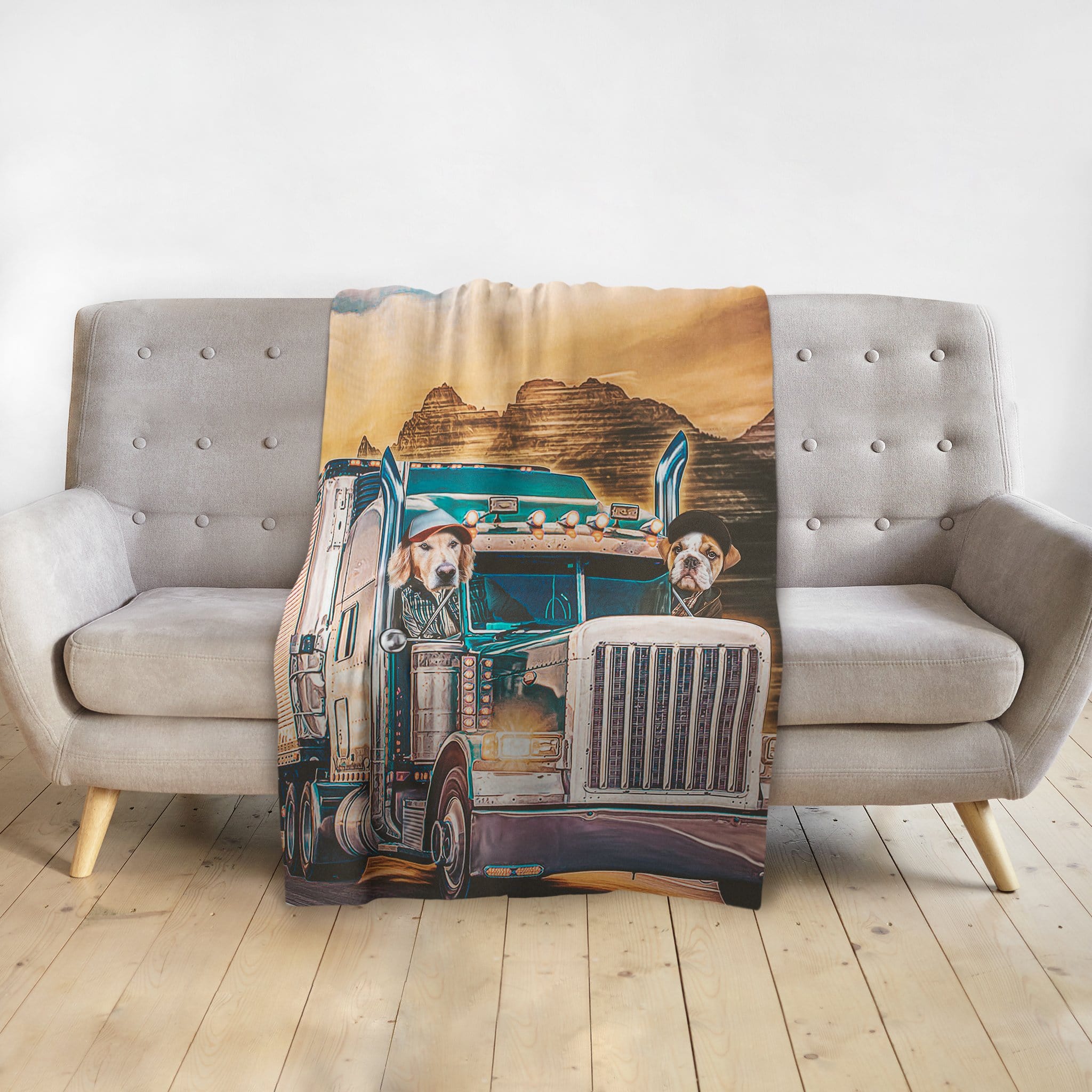 Personalized pet portrait blanket featuring two dogs in a semi-truck, draped over a gray couch.
