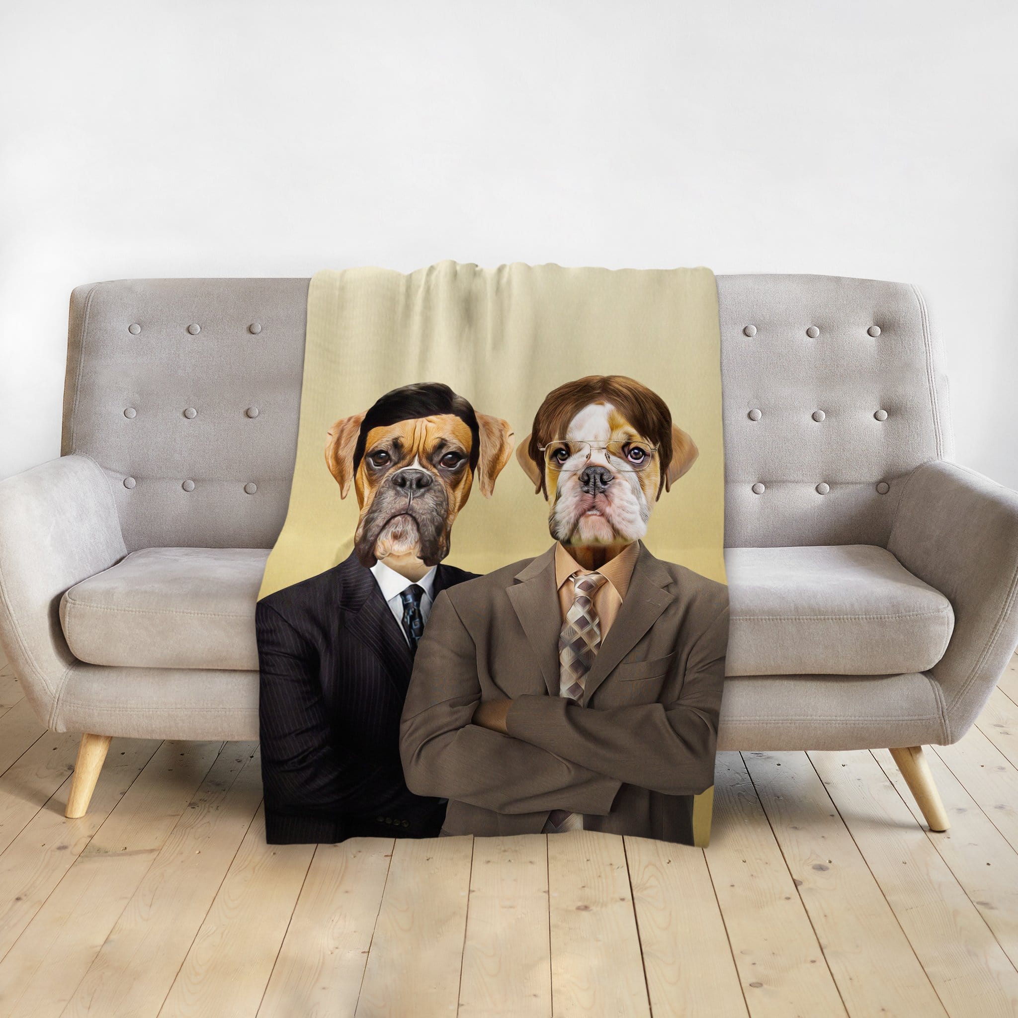 Personalized pet blanket with two dogs in business suits, draped over a gray sofa.