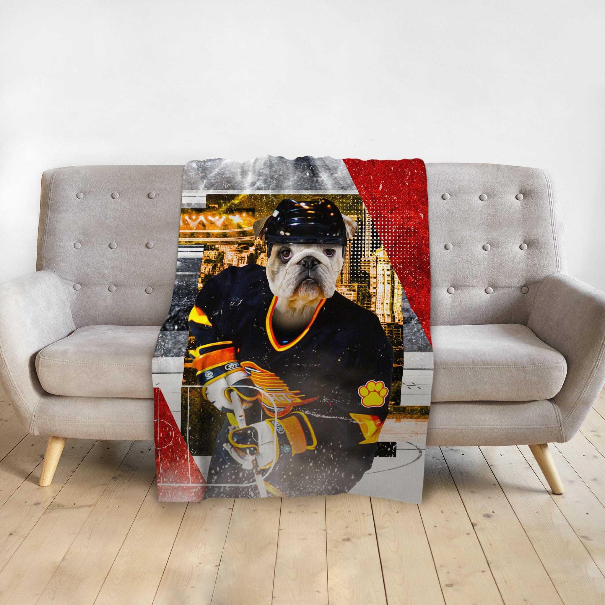 Personalized pet blanket featuring a bulldog in a hockey player portrait on a gray sofa.